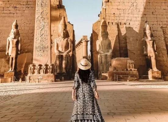 Woman standing infront of a temple, Egypt Travel Packages